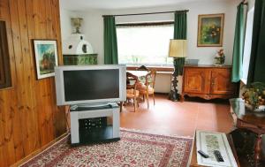 a living room with a television on a table at Casa Iolanda in Soraga