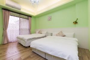 A bed or beds in a room at Iris Guest House