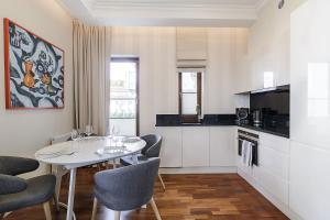 a kitchen and dining room with a table and chairs at Premier Apartment with Sauna by Grand Apartments in Sopot