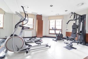 a gym with several treadmills and elliptical machines at Premier Apartment with Sauna by Grand Apartments in Sopot