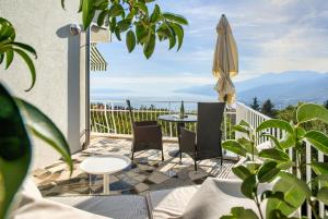 a patio with a table and an umbrella at Apartments Frlan in Kastav