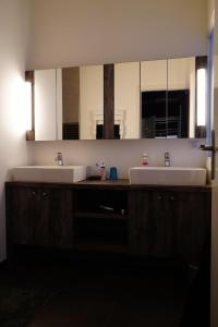 a bathroom with two sinks and a large mirror at Chalet Kizuna in Saint-Gervais-les-Bains