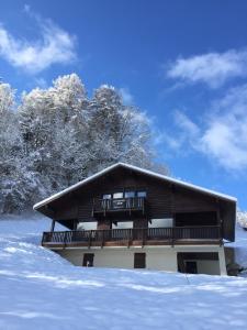 a building with a balcony in the snow at Chalet Kizuna in Saint-Gervais-les-Bains