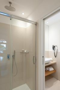 a bathroom with a shower and a sink at Résidence Terra Marina in Bonifacio