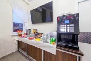 a kitchen counter with a microwave on top of it at D Hotel in Krasnodar