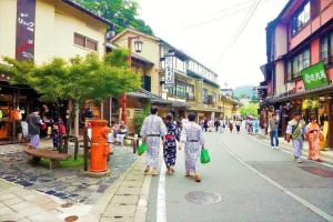 a group of people walking down a city street at Morizuya in Toyooka