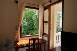 a window in a room with a table and a fan at Moon house tropical garden - Lavender in Nha Trang