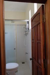 a bathroom with a shower and a toilet and a door at Moon house tropical garden - Lavender in Nha Trang
