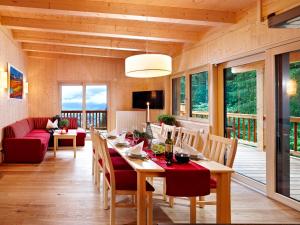 a dining room with a table and chairs and a couch at Appartement Waldhäusl in Neukirchen am Großvenediger