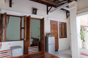 a kitchen with a table and a refrigerator at Moon house tropical garden - East side in Nha Trang