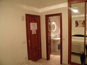 a bathroom with a door leading to a bedroom at Hostal Angelines in Madrid +90 photos