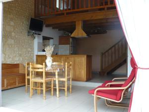 a dining room with a table and chairs at Gîte Rural Charentais in Les Essards