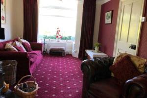 a living room with two couches and a window at Millbrook in Helston
