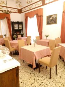 a room with a table, chairs, and a table cloth at Villa Mabel in Taormina