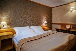 Postel nebo postele na pokoji v ubytování Hotel Akademie a depandance Vila Jarmila