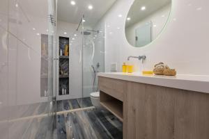 a bathroom with a sink and a toilet and a mirror at Holiday Apartments Split in Split +44 photos