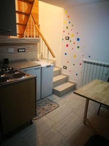 a kitchen with a staircase with a wall with colorful balls at mono locale in Turin