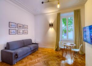a living room with a couch and a table at App Beccaria Apartments in Rome in Rome