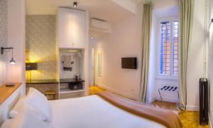 a hotel room with a large bed and a window at App Beccaria Apartments in Rome in Rome