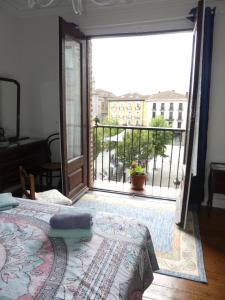 a bedroom with a door open to a balcony at Mimenza in Orduña