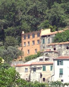 a building on the side of a hill with trees at B&B Nelly G in Carbuta