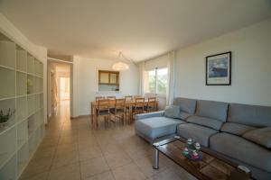 a living room with a couch and a table at Apartaments Sa Guilla in Pals
