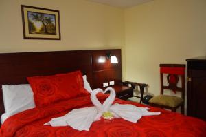 a bedroom with a bed with a wedding dress on it at Balcones del Río Hotel in Latacunga