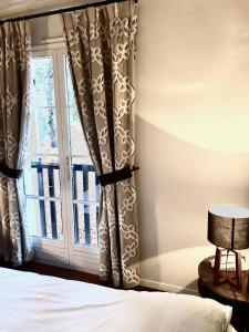 a bedroom with a bed and a window at Hostellerie Du Royal Lieu in Compiègne