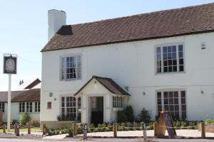 a white building with a sign in front of it at The Bell Inn in Worcester