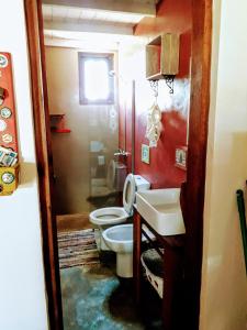 a bathroom with a toilet and a sink at DiaBro's in Punta Del Diablo
