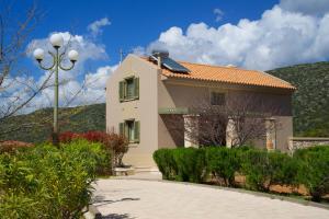 a white house with a red roof at Cephalonia Verde in Argostoli