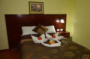 a hotel room with a bed with towels on it at Balcones del Río Hotel in Latacunga