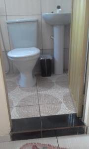 a bathroom with a toilet and a sink at Pousada águas belas in Carolina +13 photos