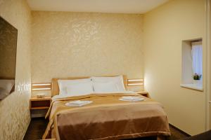 Postel nebo postele na pokoji v ubytování Hotel Akademie a depandance Vila Jarmila