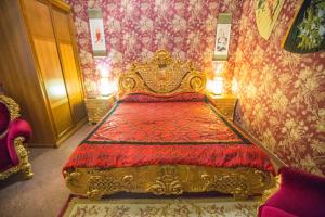 a bed room with a large bed with red pillows at Zodiak Boutique Hotel in Moscow