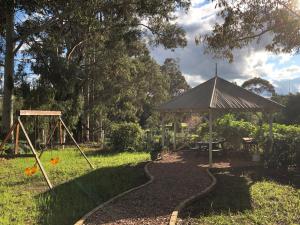 a playground with a gazebo and a swing at Country Cottages of Bridgetown in Bridgetown
