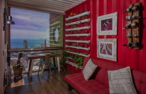a red living room with a red couch and a table at Hotel Winebox Valparaiso in Valparaíso