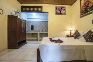 Postel nebo postele na pokoji v ubytování Tegar Guest House Ubud