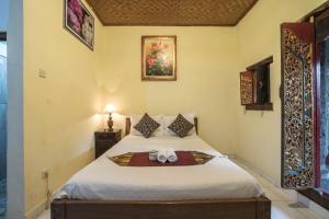 Postel nebo postele na pokoji v ubytování Tegar Guest House Ubud