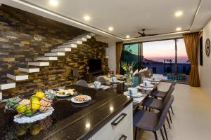 a dining room with a table with food on it at Twin Villas Seaview Kata in Kata Beach