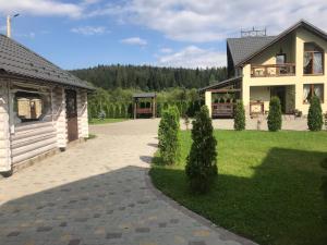 a house with a walkway next to a building at VIP House in Mykulychyn