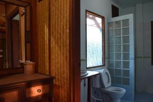 a bathroom with a toilet and a window at Indie House @ Maerim in Mae Rim