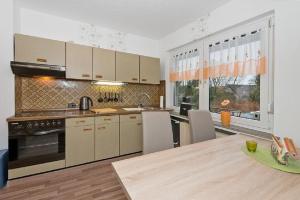 a kitchen with a table and a large window at Ferienwohnung Poppe in Loxstedt