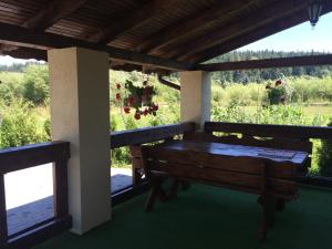 a porch with a bench and a view of a field at VIP House cottages in Mykulychyn +87 photos