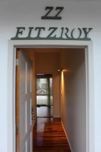 a door leading to a hallway with a sign above it at Mini Homestay in Auckland