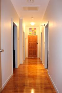 a hallway of a house with a wooden door at Mini Homestay in Auckland
