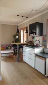 a kitchen with white cabinets and a table in it at Apartment Leopold mit Balkon in Coburg