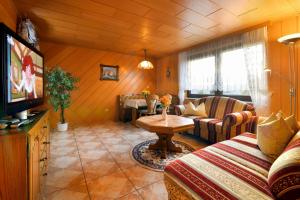 a living room with a couch and a table at Ferienhaus Richter in Drognitz