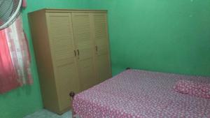 A bed or beds in a room at Wisma Sayura Syariah