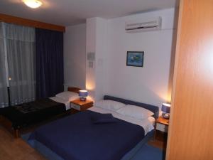 a hotel room with two beds and a window at Hotel Metković in Metković